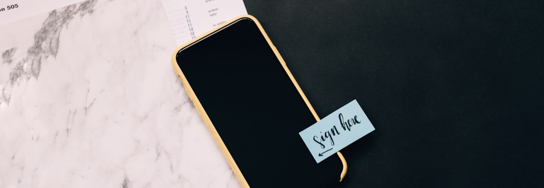 black smartphone on white pad